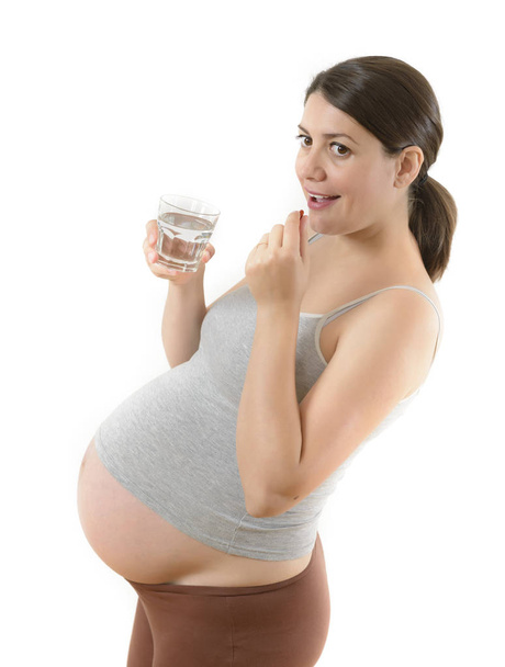Happy Pregnant Woman Taking a Pill - Fotoğraf, Görsel
