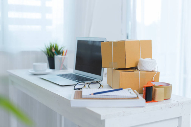 business owner working at home office packaging on background - Fotó, kép