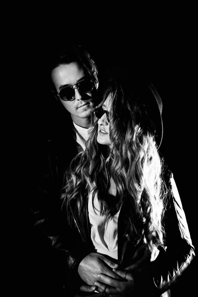 Beautiful young couple  posing in darkness - Fotó, kép
