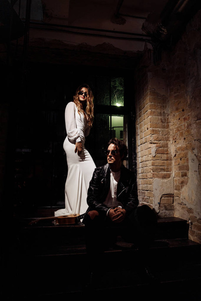 Beautiful young couple in sunglasses posing indoors - Fotoğraf, Görsel