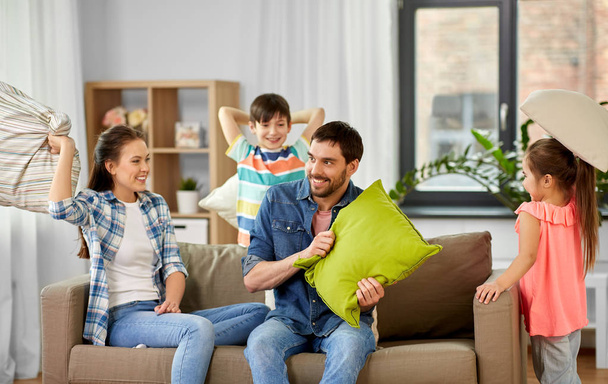 happy family having pillow fight at home - Foto, Bild