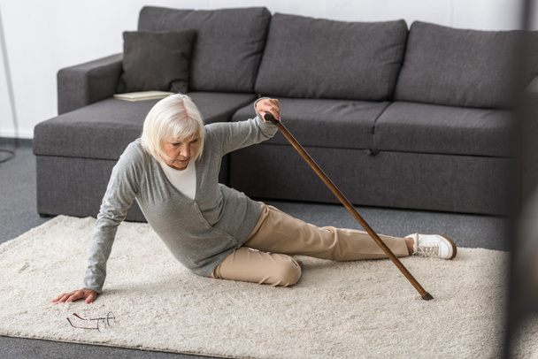 suffering senior woman with heart attack on carpet - Foto, Imagem