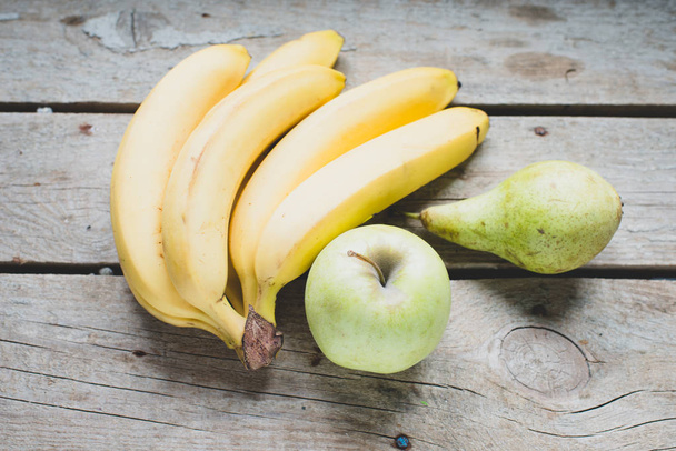 Bananas  bunch and apple on background,close up - Fotografie, Obrázek