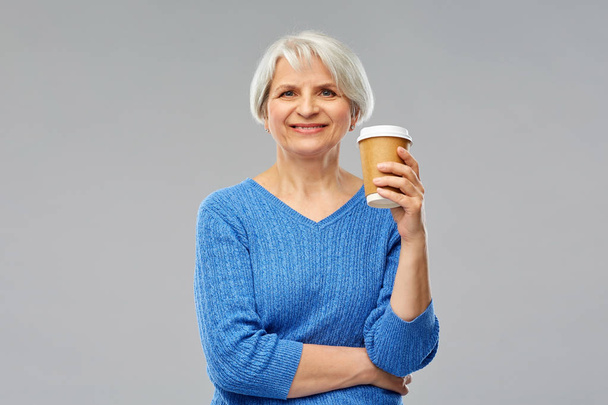 smiling senior woman with takeaway coffee cup - Fotoğraf, Görsel