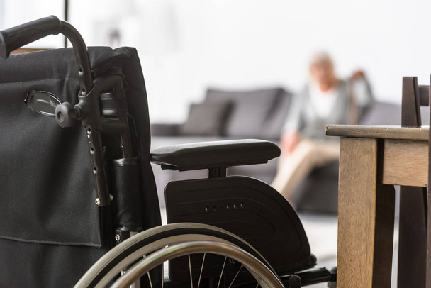 selective focus of senior woman with wheelchair on foreground - Φωτογραφία, εικόνα