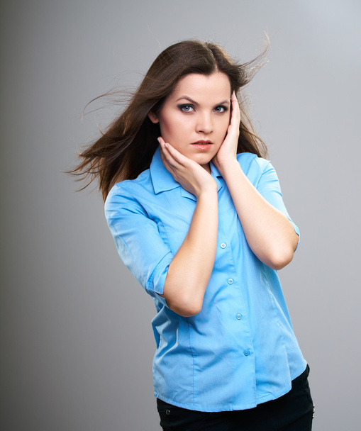 Attractive young woman in a blue shirt. Hair in motion. - Fotografie, Obrázek