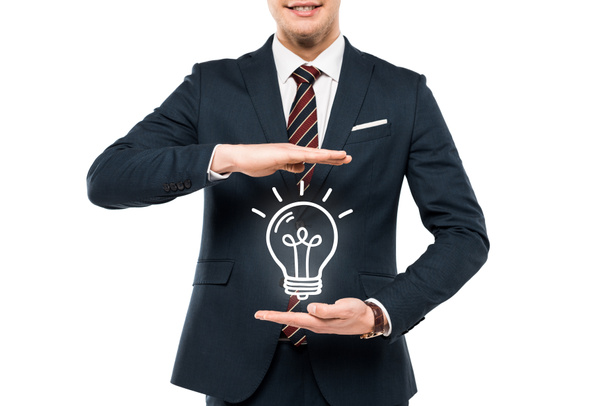 cropped view of businessman in formal wear gesturing near light bulb isolated on white  - 写真・画像