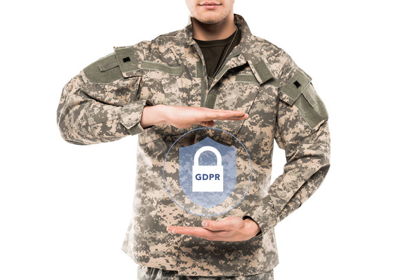 περικομμένη θέα άνθρωπος σε στρατιωτική ομοιόμορφη αγγίζοντας εικονικό λουκέτο με τον γκπδ γράμματα απομονώνονται σε λευκό  - Φωτογραφία, εικόνα