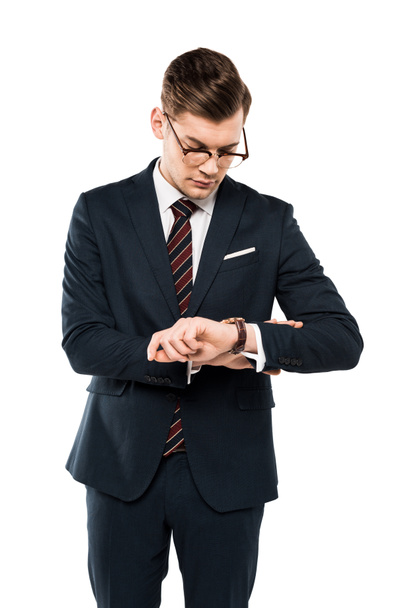 handsome businessman in glasses looking at watch isolated on white  - Fotó, kép