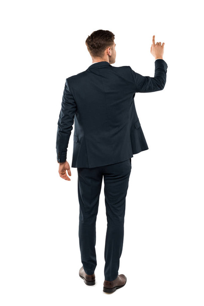 back view of businessman pointing with finger while standing isolated on white  - Fotó, kép