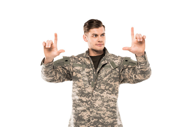 handsome man in military uniform pointing with fingers isolated on white  - Photo, image