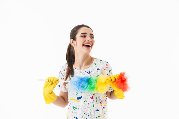 Photo of cheerful woman 20s wearing yellow rubber gloves holding - Foto, Imagem