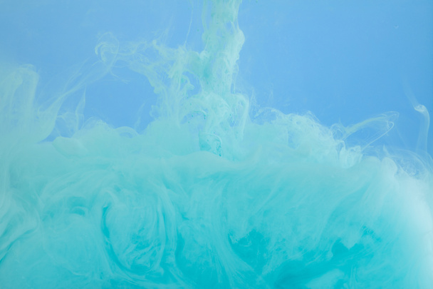 Close up view of turquoise watercolor swirls isolated on blue - Φωτογραφία, εικόνα
