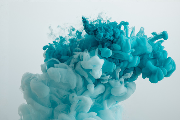 Close up view of turquoise paint swirls isolated on grey - Valokuva, kuva