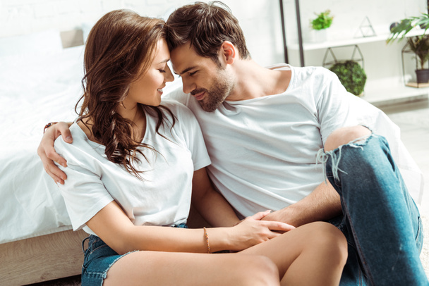 cheerful man and happy girl sitting with closed eyes in bedroom  - Foto, afbeelding