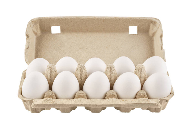 Cardboard egg box with ten eggs. Isolated. - Zdjęcie, obraz