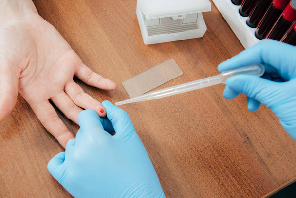 cropped view of donor and doctor obtaining blood sample - Photo, Image