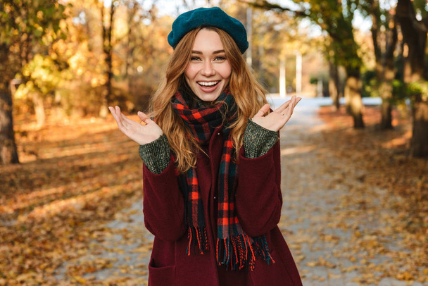Cheerful young girl with long brown hair wearing autumn - Photo, image