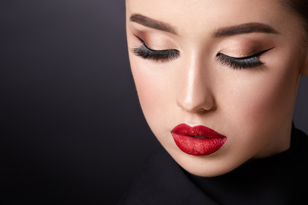 attractive young woman with evening makeup on black background - Фото, зображення