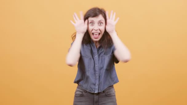 Mujer joven hace diferentes expresiones y esconde su cara
 - Metraje, vídeo