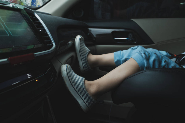 child sitting on front seat of car - 写真・画像