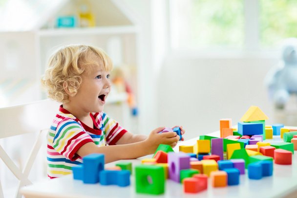 Kids toys. Child building tower of toy blocks. - Фото, зображення