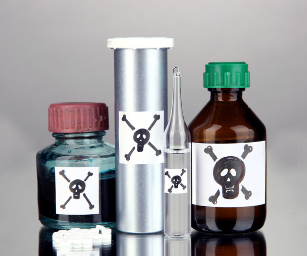 Deadly poison in bottles on grey background - Fotoğraf, Görsel