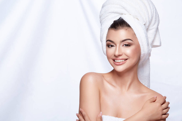 portrait of young beautiful woman with white towel on head and nude make up - Fotó, kép