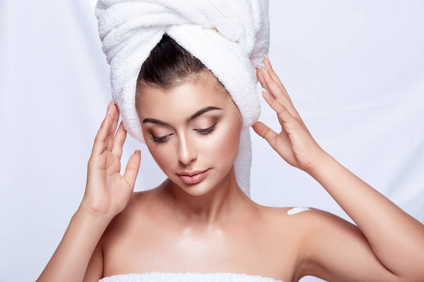 portrait of young beautiful woman with white towel on head and nude make up - Photo, Image