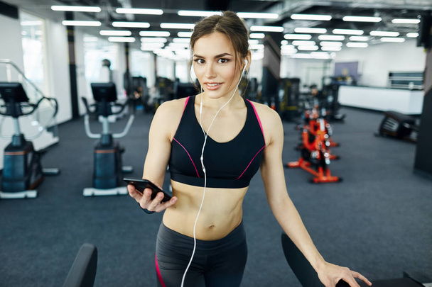 young fit woman exercising on treadmill in gym - Photo, Image