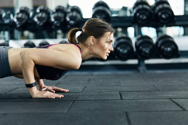 athletic sportswoman training in gym alone - 写真・画像