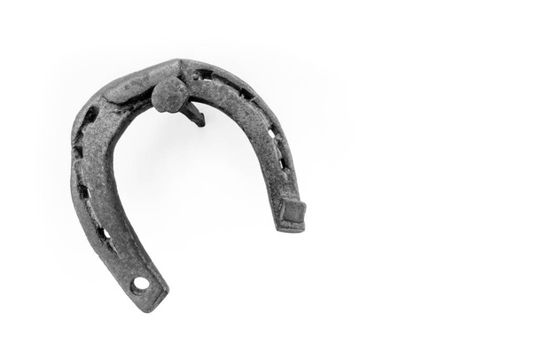 horseshoe hanging on a nail on a white background - Photo, Image