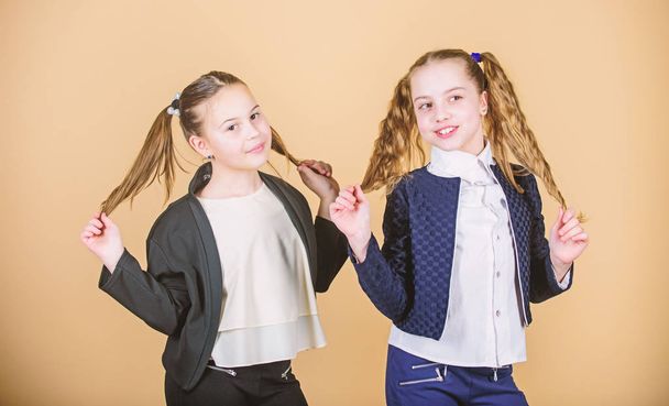 Hairstyle for female. Cheerful friends made same hairstyle for fun. We look like sisters. Best friends forever. Long hair hairstyle tips. Double ponytails hairstyle. Girls enjoy having long hair - Fotografie, Obrázek