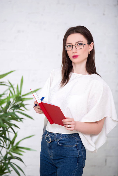 young bussiness girl is standing with notebook - Photo, image