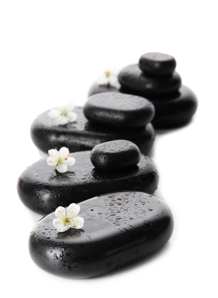 Spa stones and white flowers isolated on white - Fotó, kép