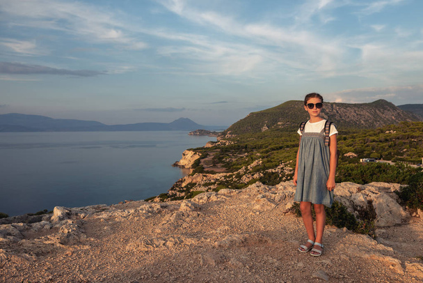 Young beautiful girl traveling along the coast of the Mediterranean Sea. - Фото, зображення