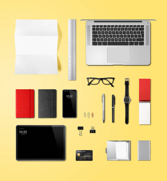 Office desk branding mockup top view isolated on yellow - Photo, Image