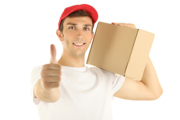 Young delivery man holding parcel, isolated on white - Photo, image