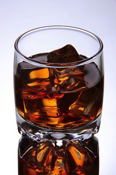 Brandy glass with ice on grey background - Fotó, kép