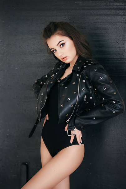 Beautiful young woman posing in black jacket  - Foto, Imagen