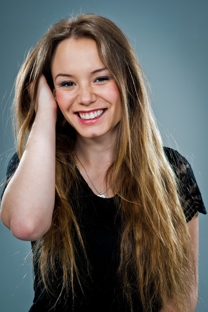 Young Happy Woman Smiling and Touching Her Hair - Fotoğraf, Görsel
