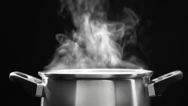 steam over cooking pot in kitchen on dark background - Footage, Video