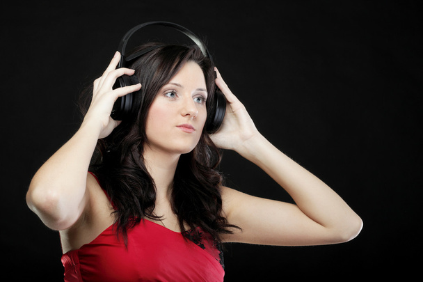 young woman listening to music on headset - Foto, Bild
