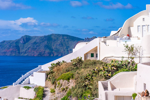 Santorini landscape with traditional whitewashed houses and view of Aegean Sea in Oia, Greece - Photo, Image