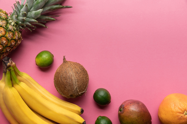 top view of ripe tropical fruits on pink background with copy space - Foto, Imagen