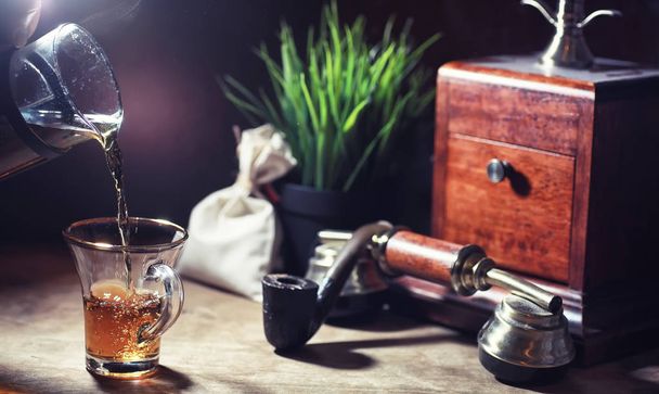 Brewing tea on a wooden table in the mornin - Fotoğraf, Görsel