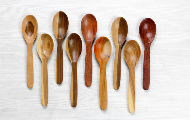 nove cucchiai di legno su sfondo bianco
 - Foto, immagini