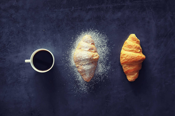 Fresh pastries on the table. French flavored croissant for breakfast. - Фото, изображение