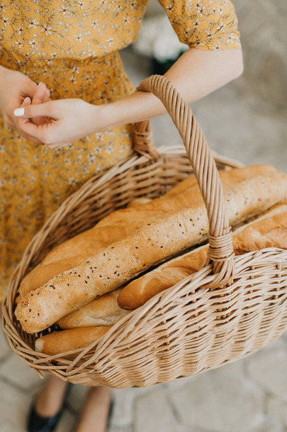 Basket with baguette in the hands of the girl - Photo, image