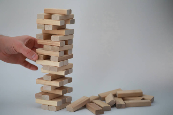 Board game jenga tower of wood sticks - Фото, изображение